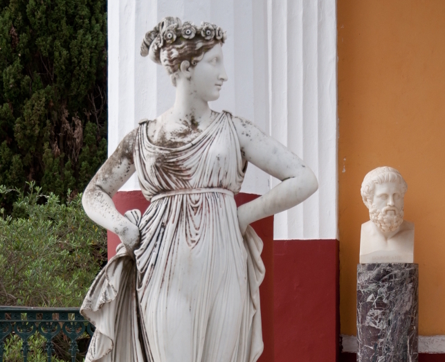 Statue of Euphrosyne at Achilleion Palace, Corfu Island, Greece. A bust of Sophocles is in the background.
